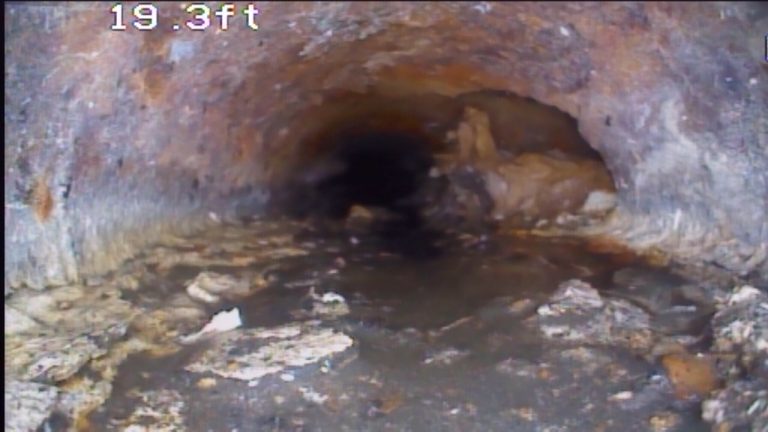 Waste Buildup in Sewer Pipe